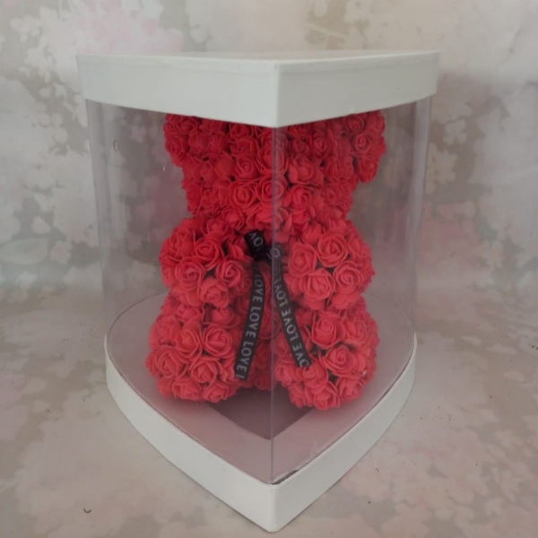 Artificial flower teddy bear in a box